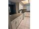 Updated kitchen showcases granite counters, white cabinets, and tiled floors at 2408 Swailes Dr # 6, Orlando, FL 32837