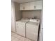 Functional laundry area equipped with a washer, a dryer, and overhead cabinet storage at 2408 Swailes Dr # 6, Orlando, FL 32837