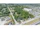 This aerial view showcases a charming home nestled among lush greenery near waterfront community amenities and ample parking at 2418 W 1St St, Sanford, FL 32771