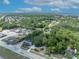 This aerial view showcases a charming home nestled among lush greenery and mature trees, near waterfront community amenities and ample parking at 2418 W 1St St, Sanford, FL 32771