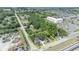 An aerial view outlines property in yellow, with lush trees surrounding the charming home near waterfront community amenities at 2418 W 1St St, Sanford, FL 32771