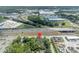 This aerial view captures the home's location near a highway and commercial areas, blending urban accessibility with private living at 2418 W 1St St, Sanford, FL 32771