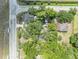 Aerial view of the property and the surrounding neighborhood with mature trees at 2418 W 1St St, Sanford, FL 32771