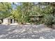 Serene backyard setting with mature trees and multiple sheds, perfect for storage at 2418 W 1St St, Sanford, FL 32771