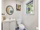Charming bathroom features custom stained glass and updated sink with vanity at 2418 W 1St St, Sanford, FL 32771