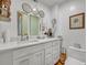 Bright bathroom features a dual vanity, marble countertop, and modern fixtures at 2418 W 1St St, Sanford, FL 32771
