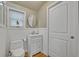 Clean bathroom features a new toilet, vanity, mirror, and wood-look floors at 2418 W 1St St, Sanford, FL 32771