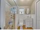 Bright bathroom featuring a glass-enclosed shower and white fixtures at 2418 W 1St St, Sanford, FL 32771