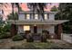 Charming two-story home with a brick porch and a neatly landscaped yard at sunset at 2418 W 1St St, Sanford, FL 32771