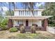 Charming two-story home with a brick porch and a neatly landscaped yard at 2418 W 1St St, Sanford, FL 32771