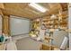 Garage interior with wood beam frame, shelving and a roll up garage door at 2418 W 1St St, Sanford, FL 32771