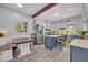Bright kitchen with blue island, breakfast nook and stainless steel refrigerator at 2418 W 1St St, Sanford, FL 32771