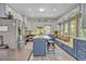 Open-concept kitchen with island, breakfast bar, window bench and stainless appliances at 2418 W 1St St, Sanford, FL 32771
