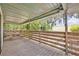 Relaxing covered outdoor patio with picnic table and railing overlooking yard at 2418 W 1St St, Sanford, FL 32771