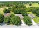 View of homes near a golf course, with mature trees and landscaping at 24720 Calusa Blvd, Eustis, FL 32736