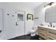 Bathroom with black and white accents, shiplap walls, and wood-look flooring, offering a modern design at 24720 Calusa Blvd, Eustis, FL 32736