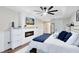 Bedroom featuring a modern fireplace, bright accents, wood-look flooring and bright natural light at 24720 Calusa Blvd, Eustis, FL 32736