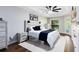 Bedroom featuring a tray ceiling, neutral colors, and wood-look flooring, offering a serene and inviting space at 24720 Calusa Blvd, Eustis, FL 32736