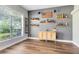 Dining room featuring a unique design with floating shelves holding decorative liquor bottles and wood-look flooring at 24720 Calusa Blvd, Eustis, FL 32736