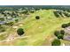 Scenic aerial view of the golf course, showcasing the expansive green fairways, sand traps, and surrounding residences at 24720 Calusa Blvd, Eustis, FL 32736