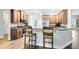 Cozy kitchen featuring wooden cabinets, granite countertops, and bar seating for casual dining at 24720 Calusa Blvd, Eustis, FL 32736