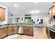 Kitchen featuring wood cabinets, granite countertops, stainless appliances, and an eat-in space at 24720 Calusa Blvd, Eustis, FL 32736