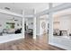 Open-concept living space with modern flooring, decorative pillars, and an inviting view into other rooms at 24720 Calusa Blvd, Eustis, FL 32736