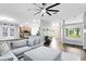 Spacious living room with a large sectional sofa, open layout, and views into the kitchen and entryway at 24720 Calusa Blvd, Eustis, FL 32736