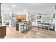 Spacious kitchen, breakfast bar and living room showcasing an open concept with wood flooring and recessed lighting at 24720 Calusa Blvd, Eustis, FL 32736