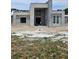 View of construction site showing partially completed house with concrete framing, window openings, and a prominent entryway at 26019 Estates Ridge Dr, Sorrento, FL 32776