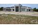 Modern home under construction, displaying its concrete framework, window placement, and architectural design at 26019 Estates Ridge Dr, Sorrento, FL 32776