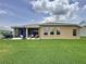 Well-maintained backyard with lush lawn, patio, and scenic views of the water and surrounding greenery at 27143 Nostalgia Dr, Leesburg, FL 34748
