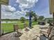 Landscaped backyard with patio, seating, grill and serene lake views, perfect for outdoor living at 27143 Nostalgia Dr, Leesburg, FL 34748