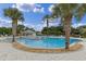Community pool featuring lounge chairs, mature palm trees, and a covered gazebo at 27143 Nostalgia Dr, Leesburg, FL 34748