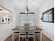 Inviting dining room with stylish light fixture and large window view at 27143 Nostalgia Dr, Leesburg, FL 34748