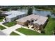 Beautiful home with lush landscaping, an attached two-car garage, and serene water views at 27143 Nostalgia Dr, Leesburg, FL 34748