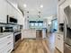 Bright kitchen featuring stainless steel appliances, white cabinets, and an island with a sink and counter seating at 27143 Nostalgia Dr, Leesburg, FL 34748