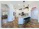 Bright kitchen with a breakfast bar, modern pendant lighting, white cabinets, and stainless steel appliances at 27143 Nostalgia Dr, Leesburg, FL 34748