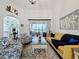 Inviting living room featuring vaulted ceilings, sliding glass door, and cozy furniture at 27143 Nostalgia Dr, Leesburg, FL 34748