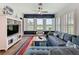 Bright living room featuring wide windows with plantation shutters and scenic lake views at 27143 Nostalgia Dr, Leesburg, FL 34748