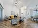 Bright, open living area with hardwood floors, high ceilings, and stylish furnishings flowing into the dining area at 27143 Nostalgia Dr, Leesburg, FL 34748