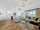 Bright living room with vaulted ceilings, hardwood floors, and a sliding glass door at 27143 Nostalgia Dr, Leesburg, FL 34748