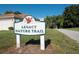 Legacy Nature Trail sign adjacent to a quiet street offering residents access to scenic walking paths at 27143 Nostalgia Dr, Leesburg, FL 34748