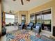 Covered patio with comfortable seating areas and ceiling fans, perfect for relaxing outdoors at 27143 Nostalgia Dr, Leesburg, FL 34748
