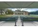 Covered shuffleboard courts offering a relaxing recreational space with benches for players and spectators at 27143 Nostalgia Dr, Leesburg, FL 34748