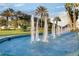 Water feature at the entrance to the Legacy of Leesburg community with lush landscaping and palm trees at 27143 Nostalgia Dr, Leesburg, FL 34748