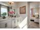 Double vanity bathroom featuring white cabinets, marble counters and floors, and modern fixtures at 2739 Ravencliffe Ter, Oviedo, FL 32765