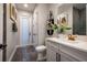 Modern bathroom with marble floors, sleek white cabinets, black fixtures, and decorative shelving at 2739 Ravencliffe Ter, Oviedo, FL 32765