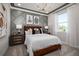 Cozy bedroom featuring a decorative gray accent wall, a brown leather headboard, and bedside tables at 2739 Ravencliffe Ter, Oviedo, FL 32765