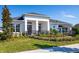 Charming home featuring a manicured lawn, dark roof, a black metal fence, and white columns at 2739 Ravencliffe Ter, Oviedo, FL 32765